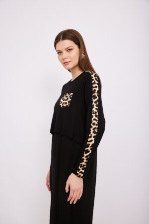 רקע שחור עם הדפסי מנומר על כיס ועל שרוול, אופנת נוחות שנלבשת בכל מצב.